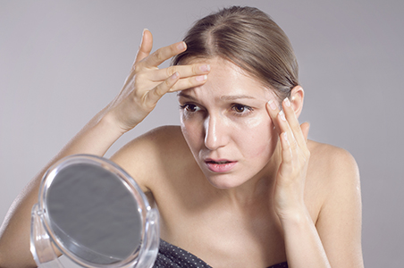 woman looking at mirror
